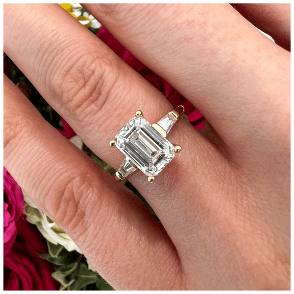 a hand with a diamond ring